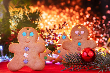 Colorful Christmas background and cinnamon cookies. Ginger delicacies. Little men with a cake. Christmas pastries, baking.の写真素材
