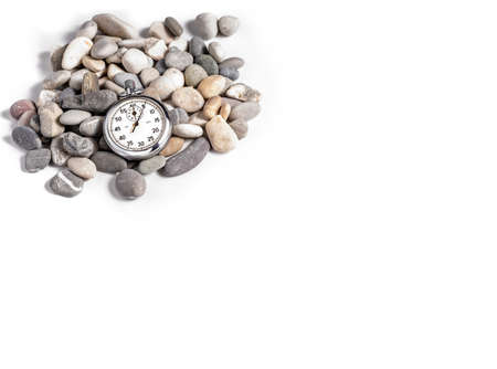 Stopwatch on several stones a white background. Timing. Time in sport.の写真素材