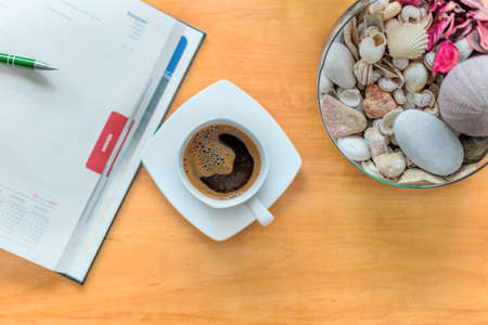 White cup of black coffee. A cup of hot drink on a wooden table. A coffee break. Relax time.の写真素材