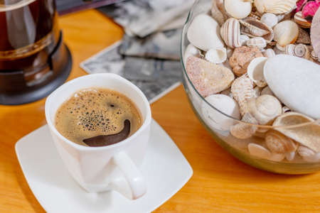 White cup of black coffee. A cup of hot drink on a wooden table. A coffee break. Relax time.の写真素材