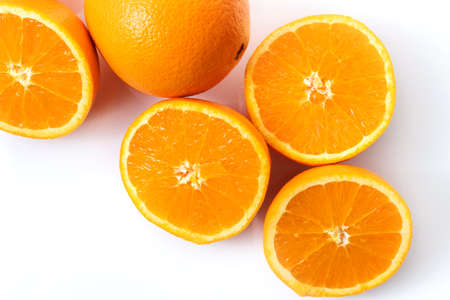 Oranges on a white background. Slice oranges.の写真素材
