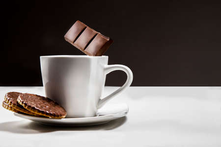 Hot chocolate with cookies. A cup and flying chocolate. Something sweet. Coffee and sweets.の写真素材