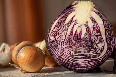 Red cabbage and other vegetables for salad. Rustic table with vegetables. Purple cabbage in a vegan diet.の写真素材