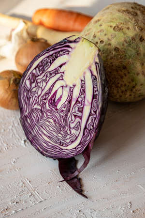 Red cabbage and other vegetables for salad. Rustic table with vegetables. Purple cabbage in a vegan diet.の写真素材