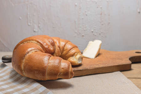 Croissant, butter for breakfast. Breakfast on a rustic table. A rural meal. Bakery products. Polish pastries.の写真素材