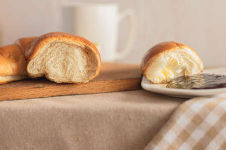Croissant with coffee, chocolate, tea for breakfast. Rustic table in the morning. Plum jam for breads. Rural leisure.の写真素材