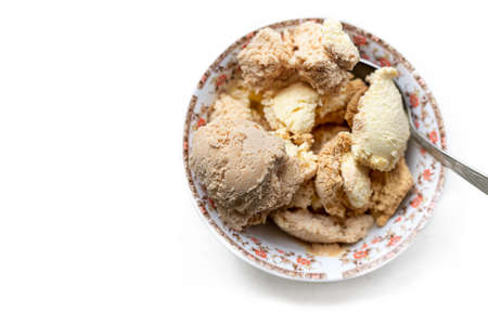 Vanilla, coffee and nut ice cream in a bowl on a light background. White background and dessert...