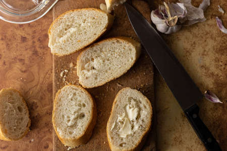 Baguette with butter and garlic. Rustic breakfast. Country cottage.の写真素材