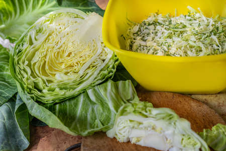 Sliced cabbage for salad. White cabbage leaves. Vegetables for dinner. Raw treats. Rural table preparation for dinner.の写真素材