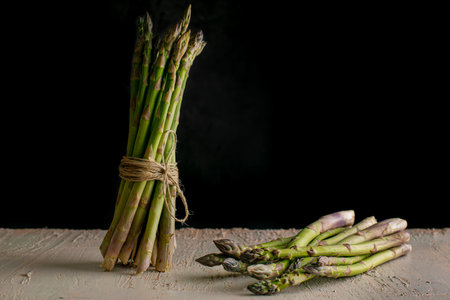 Green asparagus in a bunch. Vegetable season. May delicacies. healthy food. Vegan delicacies. dark background.の写真素材