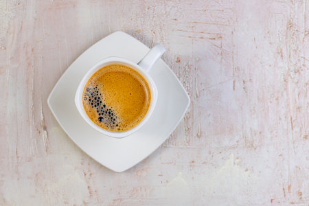 White cup of espresso on a light rustic background. Menu for cafes, restaurants. Top view of a cup of coffee. Relax with coffee in the morning.の写真素材