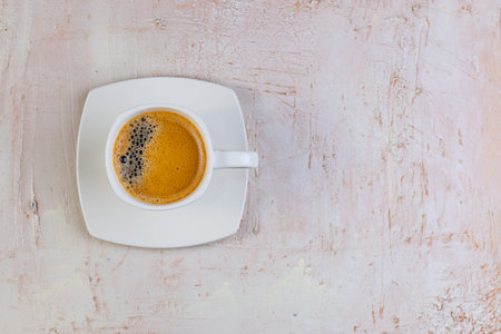 White cup of espresso on a light rustic background. Menu for cafes, restaurants. Top view of a cup of coffee. Relax with coffee in the morning.の写真素材
