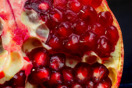 Close-up of a sliced pomegranate. Healthy food. Tropical fruits. Macro photography.の写真素材