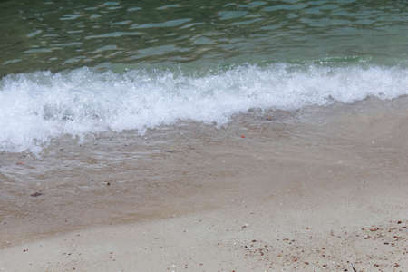 Photo of Ocean waves on the beach perfect for screen backgroundsの写真素材