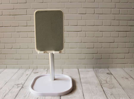 Photo of a white cell phone holder for watching, chatting and video callingの写真素材