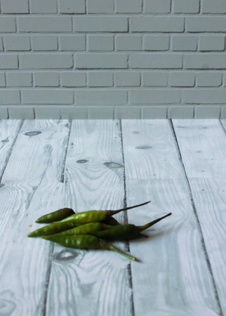 Photo of six cayenne peppers, they are small and green in color but the level of spiciness is very spicy compared to other types of chiliの写真素材