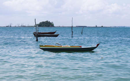Photo of a boat for fishing over the sea against a blue sky in the background and in a sunny weatherの写真素材