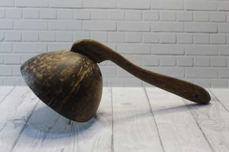 Traditional Indonesian rice ladle made of coconut shell and woodの写真素材