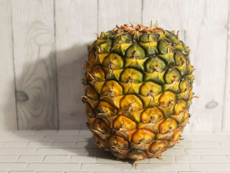 Photo of a Pineapple on a wooden wallの写真素材