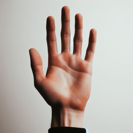 Man's hand showing five fingers on a gray background. The concept of the number five.の素材