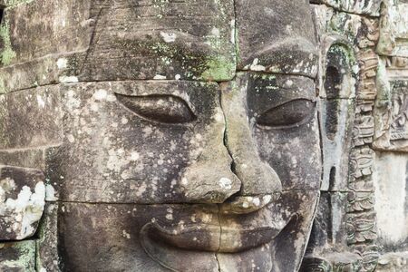 Ancient Buddha's face in temple of Angkor Cambodiaの写真素材