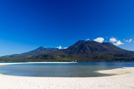 Beautiful tropical Island with white sand and volcano in the background. Camiguin. Philippinesの写真素材