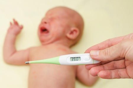 thermometer with high temperature and sick newborn child with alergy rash cries for painの写真素材