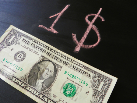 One dollar banknote on the black background and red dollar paintの写真素材