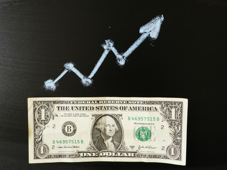One dollar banknote on the blach background and blue graph elementの写真素材
