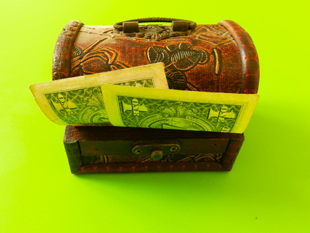 Box with one dollar banknotes on the green backgroundの写真素材