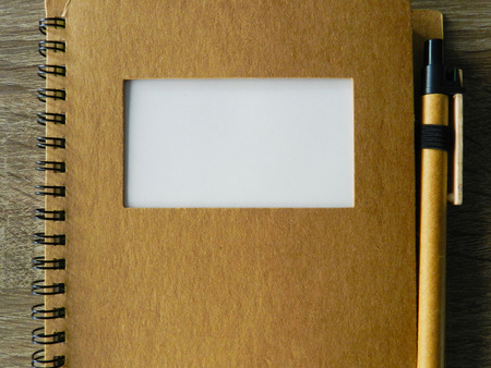 Brown notebook with pen and white space for headlineの写真素材
