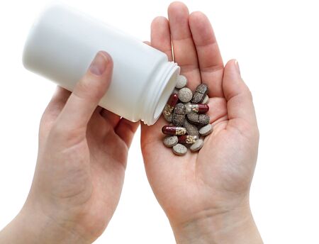 Tablets and capsules on hand at the girlの写真素材