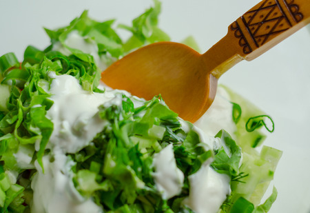 egg salad with herbs in a glass bowl, close-up, rustic style.wooden spoonの写真素材