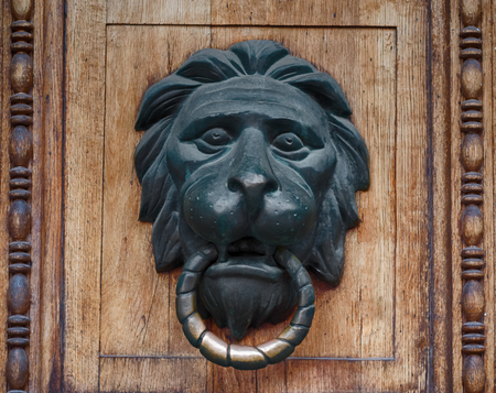 Door handle in the form of a bronze lion's head with a ringの写真素材