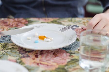 Woman eating drugs, tablets and pillsの写真素材