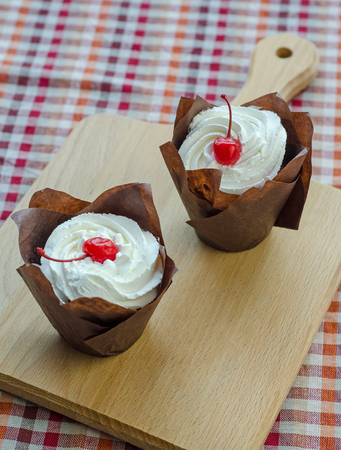 Closeup cake with cherries and cream cheese.の写真素材