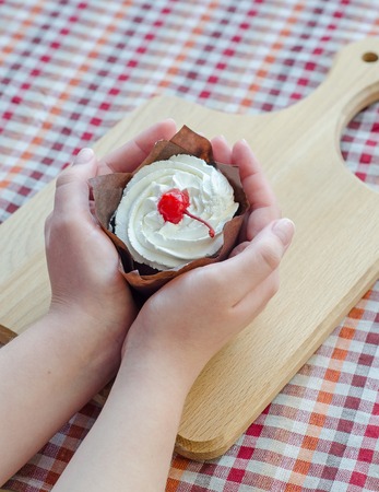 In female hands cottage cheese cake with cherriesの写真素材