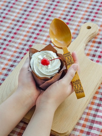 In female hands cottage cheese cake with cherriesの写真素材
