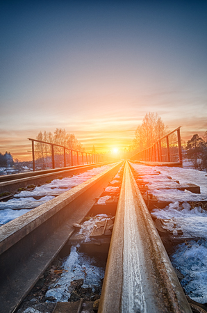 Curved railroad in sunsetの写真素材