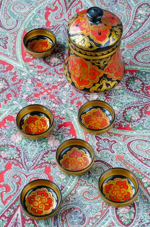 Russian traditional Khokhloma dishes on a red handkerchief. Vintageの写真素材