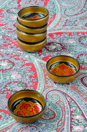 Russian traditional Khokhloma dishes on a red handkerchief. Vintageの写真素材