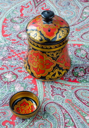 Russian traditional Khokhloma dishes on a red handkerchief. Vintageの写真素材