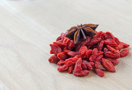 Goji berries and clove on a wooden Board. Closeupの写真素材