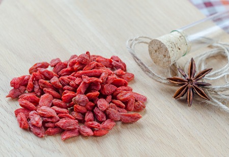 Goji berries and clove on a wooden Board. Closeupの写真素材