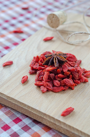 Goji berries and clove on a wooden Board. Closeupの写真素材