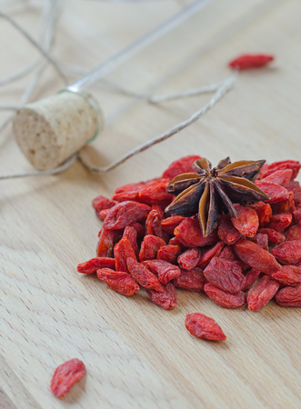 Goji berries and clove on a wooden Board. Closeupの写真素材