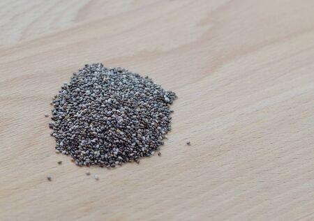 Chia seeds on wooden cutting board. Closeup photo.の写真素材