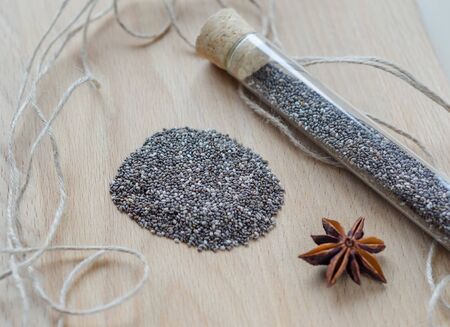 Chia seeds on wooden cutting board. Closeup photo.の写真素材