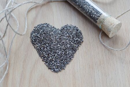 Chia seeds on wooden cutting board. Closeup photo.の写真素材