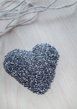 Chia seeds on wooden cutting board. Closeup photo.の写真素材